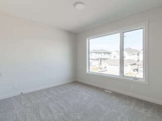 Step into this bright and airy room, featuring plush grey carpeting that adds warmth and comfort.