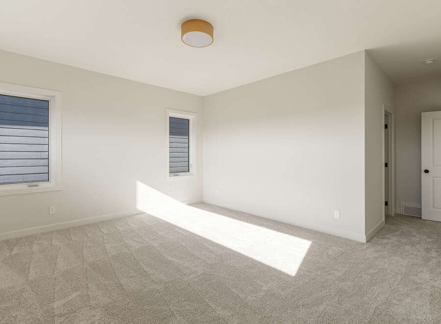 Step into this bright and airy bedroom, featuring plush carpeting that adds warmth and comfort.
