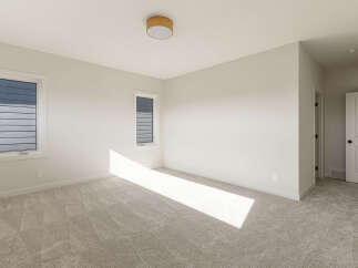 Step into this bright and airy bedroom, featuring plush carpeting that adds warmth and comfort.