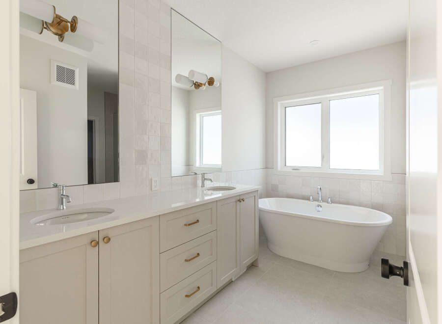 Experience luxury in this stunning bathroom featuring a freestanding soaking tub, perfect for unwinding after a long day.