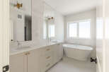 Experience luxury in this stunning bathroom featuring a freestanding soaking tub, perfect for unwinding after a long day.