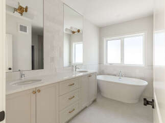 Experience luxury in this stunning bathroom featuring a freestanding soaking tub, perfect for unwinding after a long day.