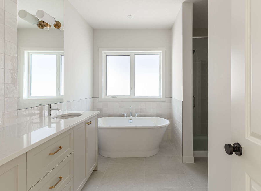 Experience luxury in this modern bathroom, featuring a freestanding soaking tub perfect for relaxation.