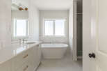 Experience luxury in this modern bathroom, featuring a freestanding soaking tub perfect for relaxation.