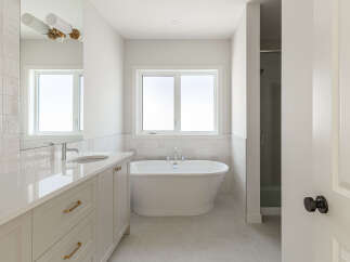 Experience luxury in this modern bathroom, featuring a freestanding soaking tub perfect for relaxation.