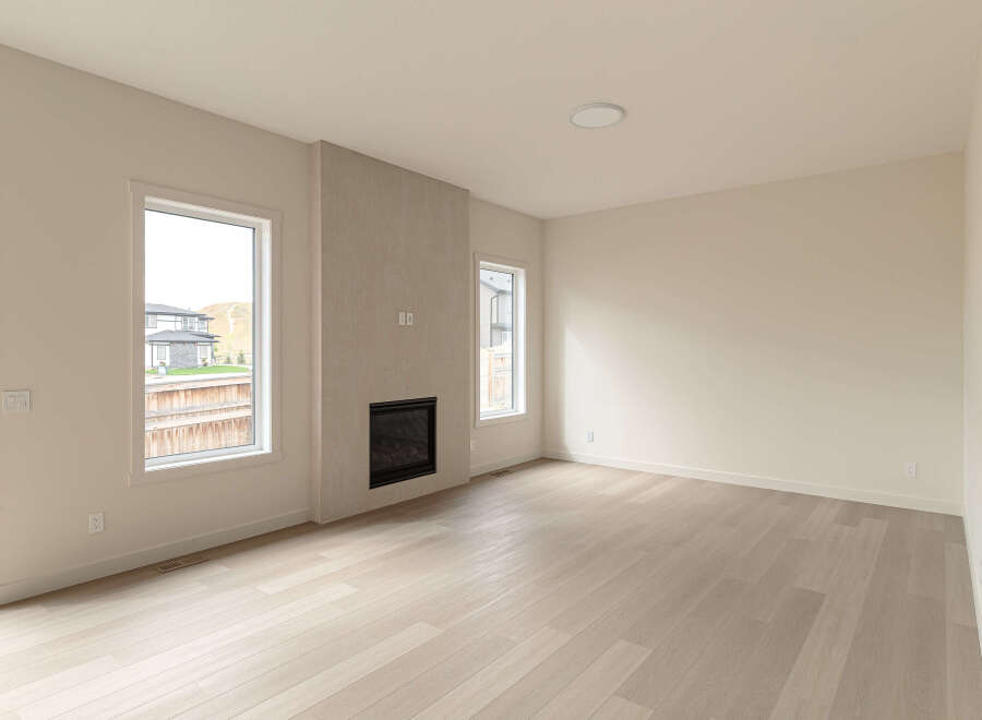 Experience modern living in this spacious room featuring a sleek gas fireplace as the focal point.
