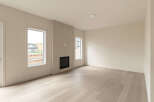 Experience modern living in this spacious room featuring a sleek gas fireplace as the focal point.