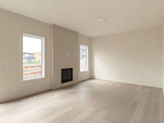 Experience modern living in this spacious room featuring a sleek gas fireplace as the focal point.