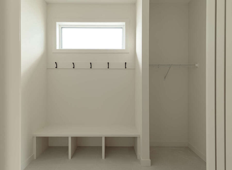 This mudroom features a built-in bench with storage cubbies, perfect for organizing shoes and bags.