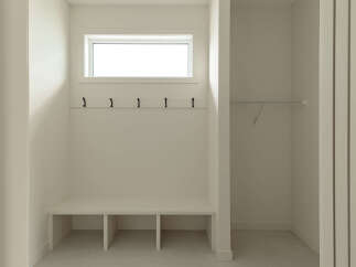 This mudroom features a built-in bench with storage cubbies, perfect for organizing shoes and bags.