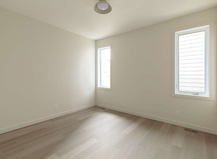 This bright and airy room features a neutral color palette, creating a serene and versatile space.