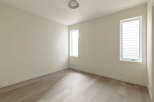 This bright and airy room features a neutral color palette, creating a serene and versatile space.
