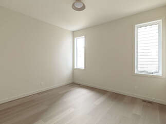 This bright and airy room features a neutral color palette, creating a serene and versatile space.