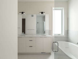 Experience luxury in this modern bathroom featuring a spacious double vanity with sleek cabinetry and ample counter space.