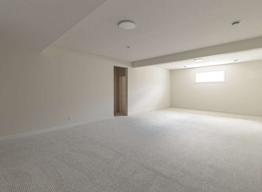 This spacious, newly carpeted room offers a bright and airy atmosphere, perfect for relaxation or entertainment.