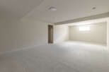 This spacious, newly carpeted room offers a bright and airy atmosphere, perfect for relaxation or entertainment.