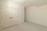 Step into this inviting room, featuring a spacious closet with double doors and elegant black hardware.