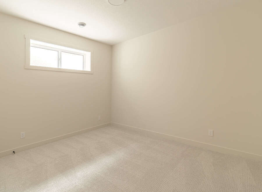 This empty room features a neutral color palette, making it a versatile space ready for your personal touch.