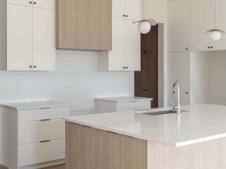 Experience modern luxury in this stunning kitchen, featuring sleek white cabinetry complemented by warm wood accents on the island and range hood.