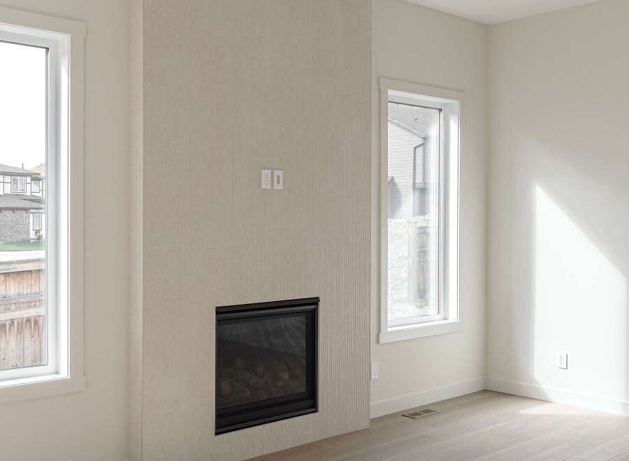 Experience modern living in this bright and airy room featuring a sleek gas fireplace as the focal point.