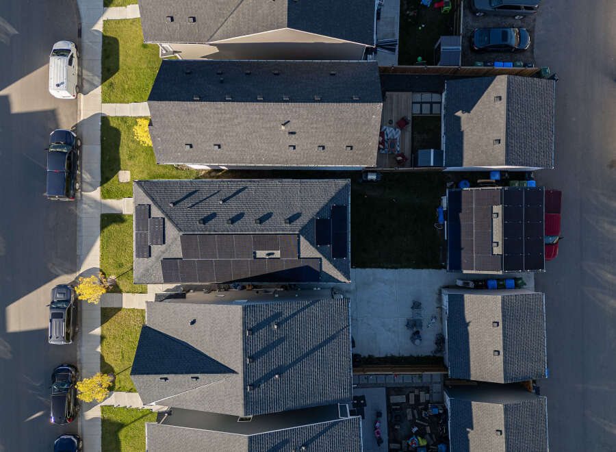 Discover modern living in this suburban neighborhood, featuring homes with sleek asphalt shingle roofs and energy-efficient solar panels.