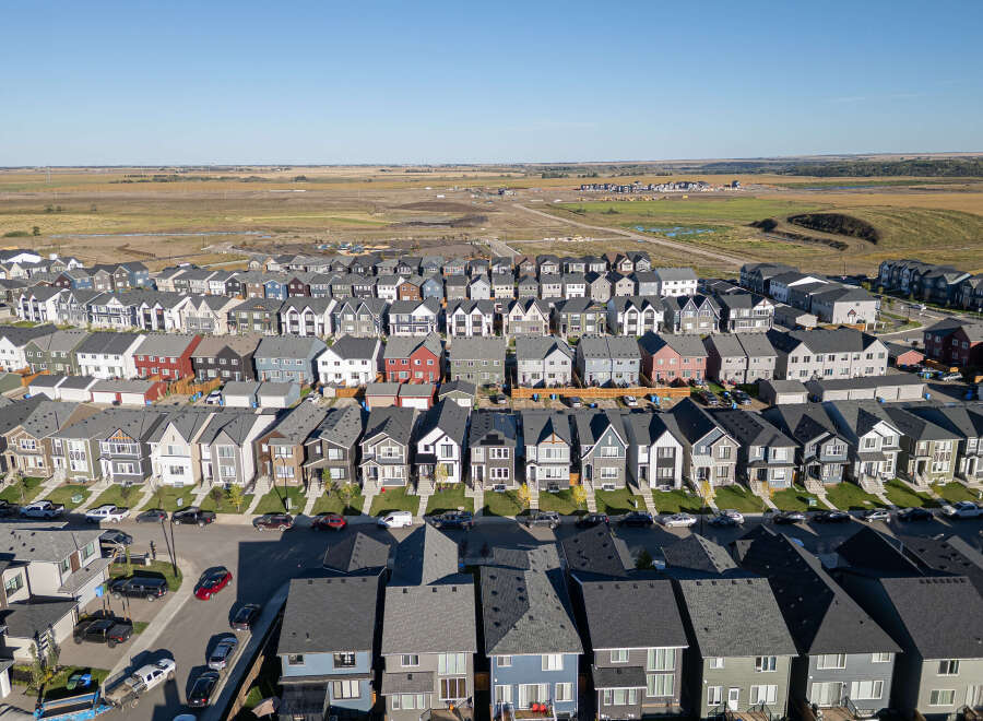 Discover this stunning aerial view of a modern suburban neighborhood, showcasing a diverse array of contemporary homes with varied architectural styles and color palettes.