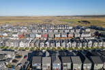 Discover this stunning aerial view of a modern suburban neighborhood, showcasing a diverse array of contemporary homes with varied architectural styles and color palettes.