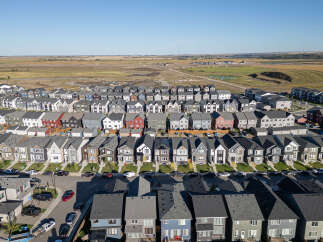 Discover this stunning aerial view of a modern suburban neighborhood, showcasing a diverse array of contemporary homes with varied architectural styles and color palettes.