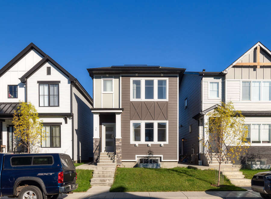 Discover modern living in this stunning townhouse featuring a sleek, contemporary design with a mix of siding and stone accents.
