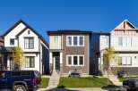 Discover modern living in this stunning townhouse featuring a sleek, contemporary design with a mix of siding and stone accents.