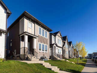 Discover modern living in this row of stylish townhouses, featuring a blend of contemporary siding and architectural accents.