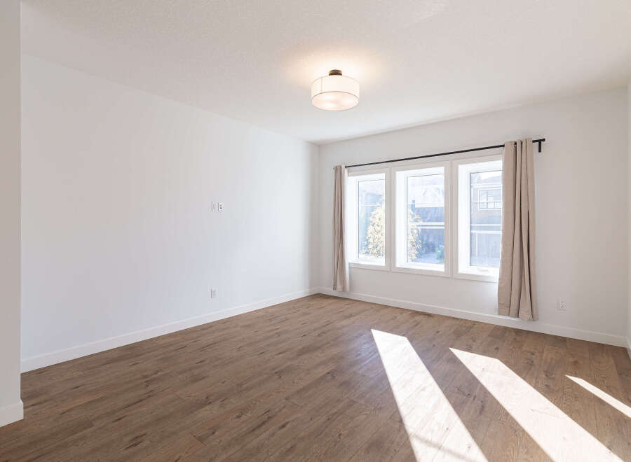 Bright and airy living space featuring a large window with natural light streaming in.