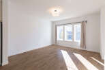 Bright and airy living space featuring a large window with natural light streaming in.