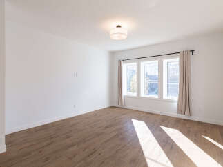 Bright and airy living space featuring a large window with natural light streaming in.