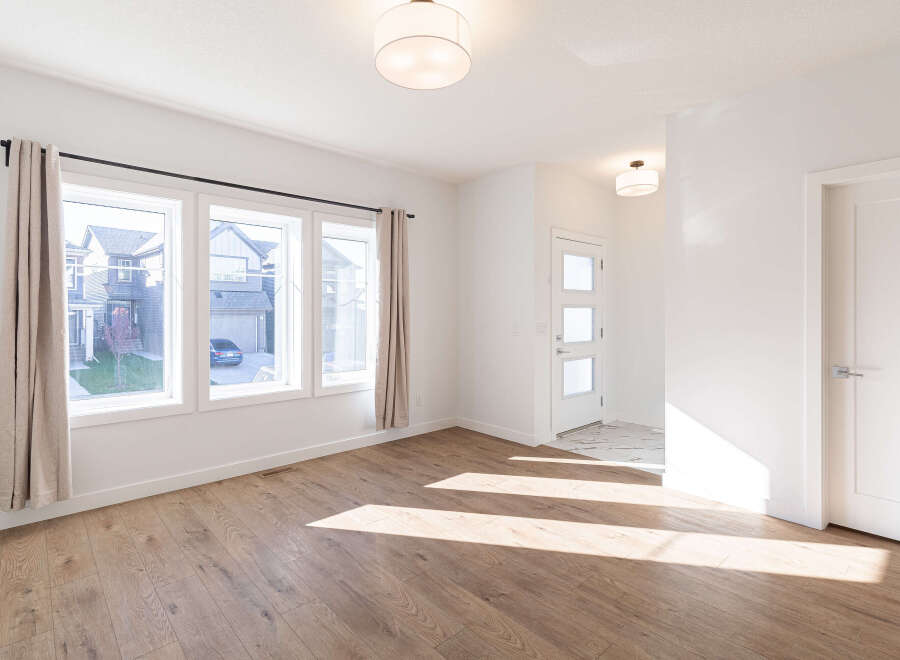 Step into this bright and airy living space, featuring a large bay window that floods the room with natural light.