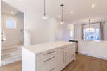 Experience modern living in this stunning kitchen featuring a spacious island with ample counter space and sleek cabinetry.