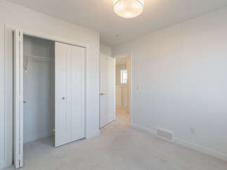 Step into this bright and airy bedroom, featuring a spacious closet with sliding doors, perfect for all your storage needs.