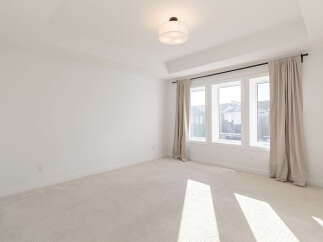 This spacious room features a coffered ceiling with recessed lighting, creating an elegant ambiance.