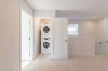 Discover the convenience of a stacked Whirlpool washer and dryer, neatly tucked away in a dedicated laundry closet.