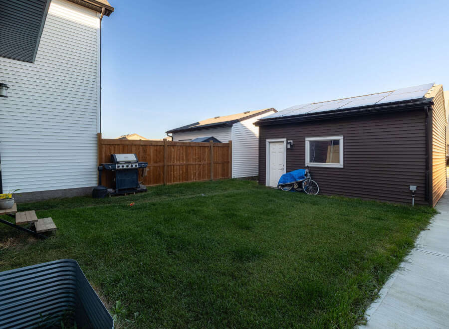 Discover this charming backyard featuring a well-maintained lawn, perfect for outdoor activities.