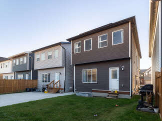 Discover modern living in this row of townhouses featuring sleek siding and ample windows for natural light.
