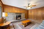 Cozy living room featuring a prominent brick fireplace with a lit fire, perfect for gathering on cool evenings.