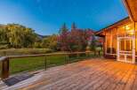 Enjoy breathtaking views from this expansive wooden deck, perfect for outdoor entertaining or quiet relaxation.