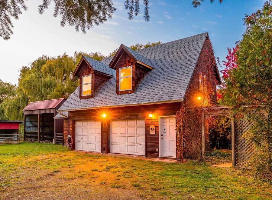 Discover this charming property featuring a spacious two-car garage with ample overhead storage, perfect for vehicles and hobbies.