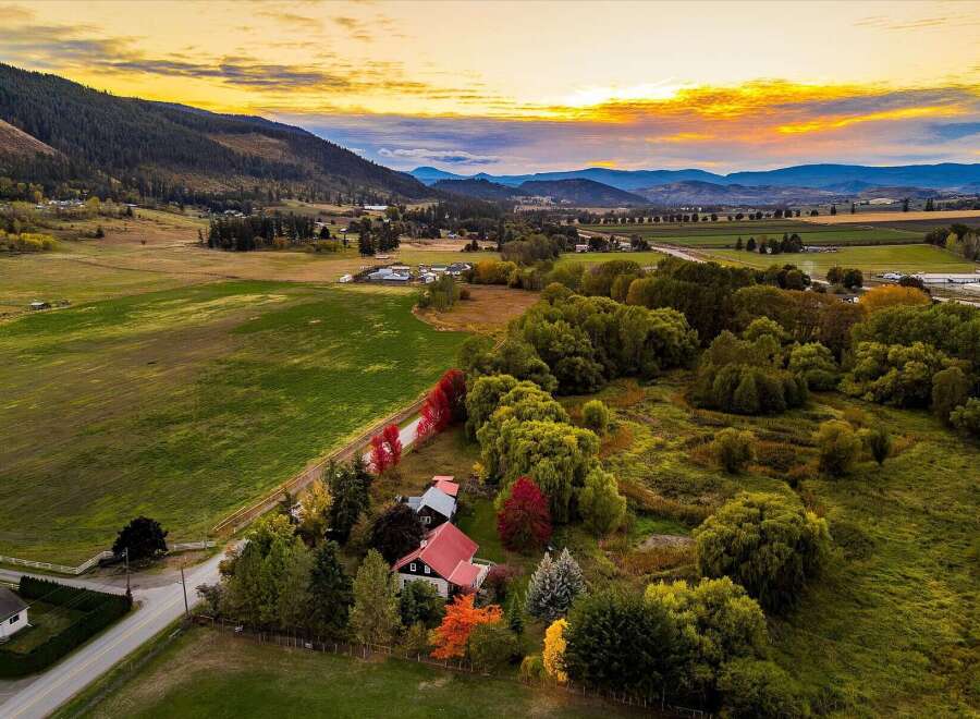 Experience the beauty of autumn in this stunning rural property, featuring a charming home nestled amongst vibrant fall foliage.