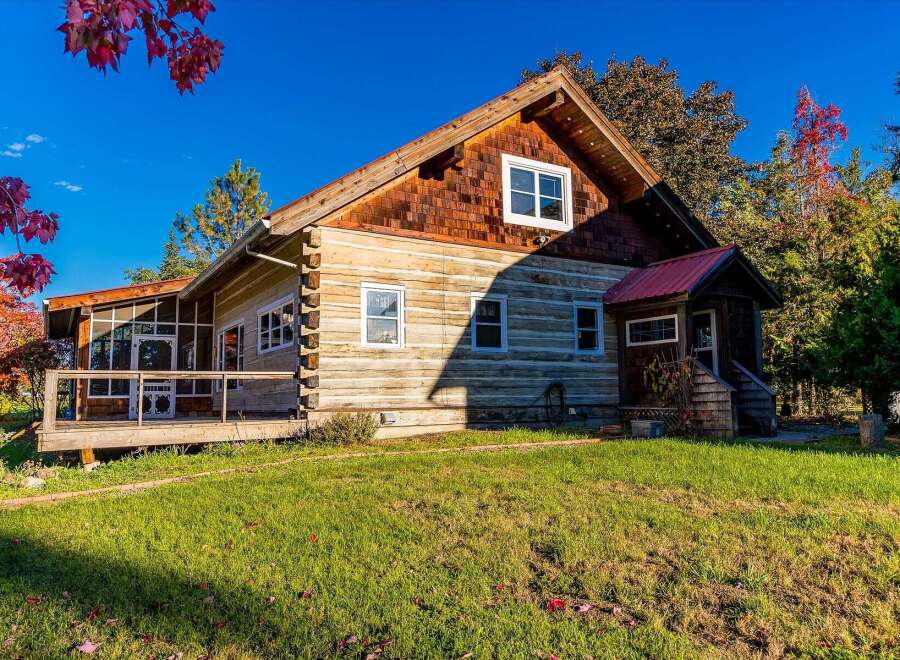 Experience rustic charm in this beautiful log cabin, nestled amidst vibrant autumn foliage.