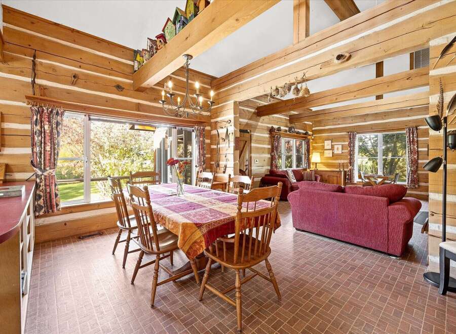 Experience rustic charm in this log cabin dining and living area.