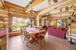 Experience rustic charm in this log cabin dining and living area.