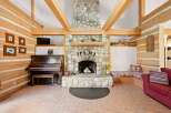 Experience rustic charm in this inviting living space, featuring a grand stone fireplace as the centerpiece.
