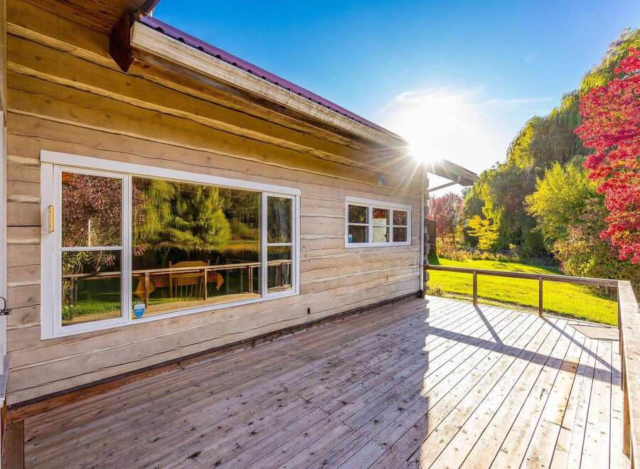 Enjoy the stunning natural beauty surrounding this log home, perfect for a peaceful retreat.